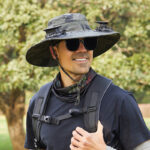 Gardener wearing solar fan hat while working outdoors