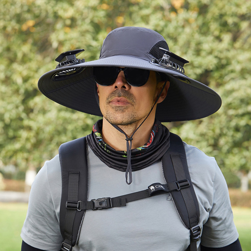 Outdoor hat with solar panel powering dual cooling fans