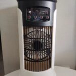 User adding ice cubes into the water tank of a desktop cooler