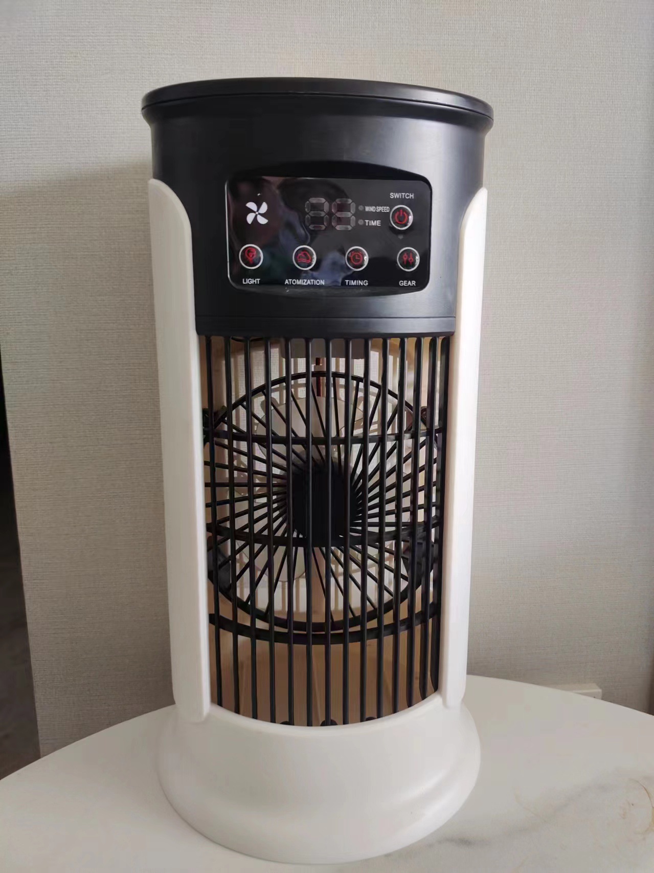 User adding ice cubes into the water tank of a desktop cooler